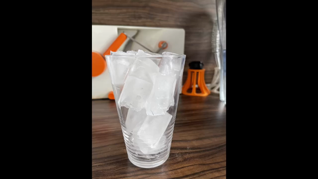 A still frame animation of a glass filled with ice cubes that is getting an espresso and a shot of milk poured into. 