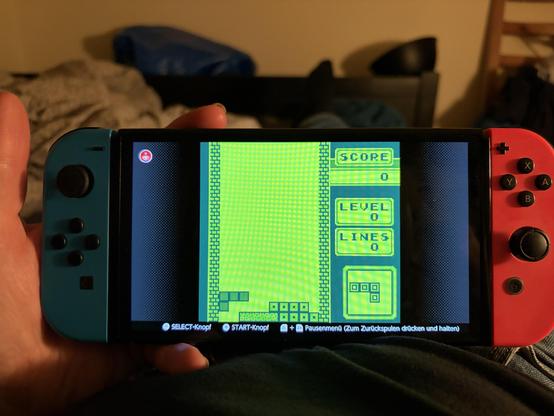 Picture of a Nintendo switch with the classic monochrome Tetris game on the screen. 
