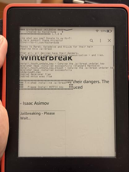 A kindle ereader showing a screen with small font script. Looks a bit scrambled and misaligned. In bold "Winterbreak" can be read in between the smaller text. 