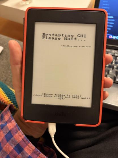 Kindle ebook reader restarting and showing text on the screen advising the user to wait for reboot 
